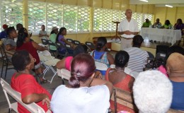 Minister of Communities, Ronald Bulkan interacting with residents of East La Penitence (GINA photo)
