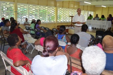 Minister of Communities, Ronald Bulkan interacting with residents of East La Penitence (GINA photo) 