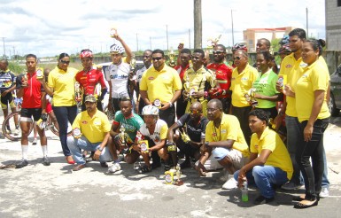 Representatives of Massy Distribution and the prize winners of yesterday’s road race pose for a photo following the completion of the event at Schoonord. (Orlando Charles photo)
