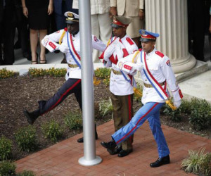 The Cuban flag is carried out of the Cuban Embassy by an honor guard during an official ceremony in Washington July 20, 2015. The Cuban flag was raised over Havana’s embassy in Washington on Monday for the first time in 54 years as the United States and Cuba formally restored relations. (Reuters/Gary Cameron)