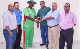 Amazon Warriors coach and former Georgetown Cricket Club player Carl Hooper receives his award from GCC president Lionel Jaikaran at a simple ceremony last evening at the Providence National Stadium.

