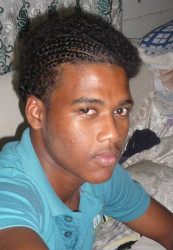 A 19-year old student of the Government Technical Institute died  yesterday after he was apparently run over by a truck at Agricola.  Dustin Crawford was killed while walking along Flour Mill Road. He has a one-year-old daughter and he lived at Lot 39, Friendship. He was a member of the Guyana Under-19 Rugby team. According to reports, persons saw the truck driving away from the scene while Crawford’s lifeless body lay on the road.  The young man’s father, Terrence Crawford, said his son was heading to the Namilco Flour Mill after they promised to sponsor the rugby team. Crawford said the police told him that they are currently investigating, but said they are yet to locate an eyewitness.  Crawford said persons in the area told him that a man on a motorcycle informed the company in question  that one of their trucks  had struck down his son. “We are trying to locate this man on the motorcycle, because we have questions,” Crawford said.  Crawford said his son’s jersey was shredded, his hands and feet were damaged and his head was crushed. When Stabroek News arrived on the scene, there was a pool of blood.   Dustin leaves his parents and five brothers, Allain, 25, Elton, 17, Dane 14, and Elisha 11, to mourn. His father described him as quiet, fun, jovial and a person who loved to tell jokes. Crawford would’ve celebrated his twentieth birthday on August 9.   