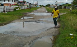 A resident manoeuvring the potholes 