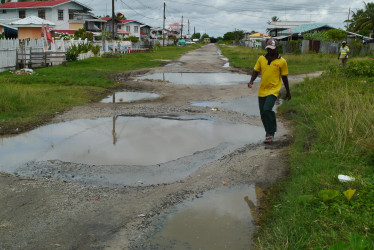 A resident manoeuvring the potholes 
