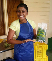 Seema Persaud with a vegetable display 