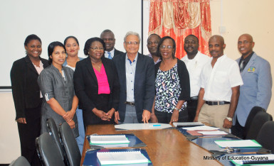 Minister of Education, Dr Rupert Roopnaraine (centre) flanked by the second batch of research grant awardees and others.