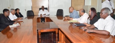 Finance Minister Winston Jordan (centre) and his team (at left), meeting yesterday with the PPP’s team on this year’s budget. (GINA photo) 