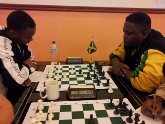Anthony Drayton (left) of Guyana opposes Andrew Mellace of Jamaica during last year’s Umada Cup which was held in Guyana. The tournament was hosted by the World Chess Federation.