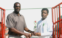Alphius Bookie receives his MVP award from Match Referee, ex-Guyana and West Indies pacer Rayon King