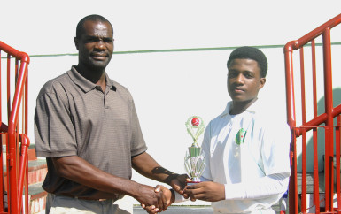 Alphius Bookie receives his MVP award from Match Referee, ex-Guyana and West Indies pacer Rayon King 