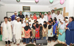 President David Granger, Minister of Social Cohesion Amna Ally and members of the Guyana United Sadr Islamic Anjuman’s Board, as they took time to take a photograph with the children at the two orphanages. (Minister of the Presidency photo)