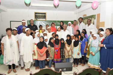 President David Granger, Minister of Social Cohesion Amna Ally and members of the Guyana United Sadr Islamic Anjuman’s Board, as they took time to take a photograph with the children at the two orphanages. (Minister of the Presidency photo) 