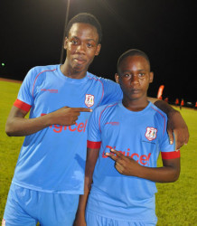 Jaleel Hamilton (left) and Ryan Hackett of Chase Academy are all smiles following their easy semi-final win over Annai Secondary at the Leonora Sports Facility yesterday. 