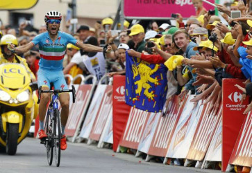 Astana rider Vincenzo Nibali of Italy celebrates as he crosses the finish line to win the 138-km (85.74 miles) 19th stage of the 102nd Tour de France cycling race from Saint-Jean-de-Maurienne to La Toussuire-Les Sybelles in the French Alps mountains, France, yesterday. REUTERS/STEFANO RELLANDINI