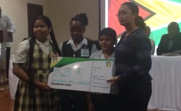Solomon Cherai (second from right) and Shania Eastman (second from left), of Success Elementary, and Celine Farinha (left), of Peter’s Hall Primary, the top three performers at the NGSA, and a representative from Fly Jamaica.