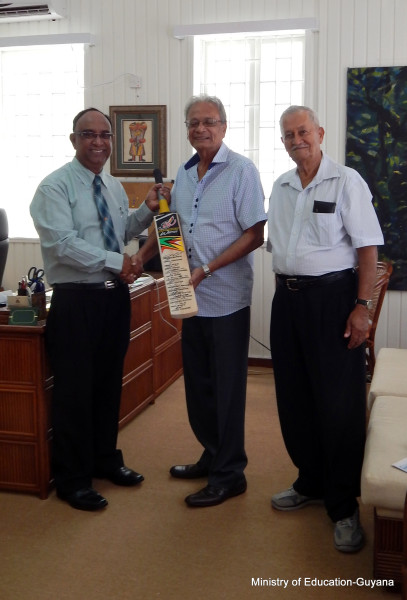 The presentation was done by Omar Khan (left), Team Manager - Guyana Amazon Warriors and Ramnarain Ramroop, Director - Guyana Amazon Warriors Team. (Ministry of Education photo)