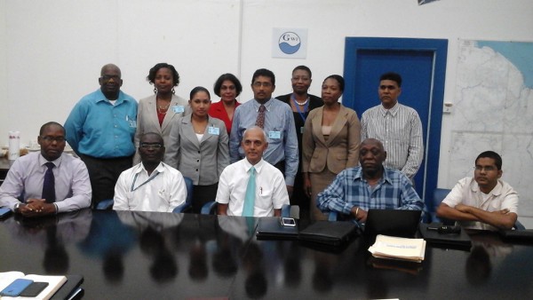 Minister Ronald Bulkan (seated at centre) with senior management and staff of the customer services team. (GWI photo)