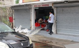 Bailing water from a King Street store