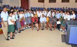 Minister within the Ministry of Indigenous People’s Affairs, Valerie Garrido-Lowe (seated at left), Minister of Education,  Dr. Rupert Roopnaraine (seated at centre) and Senior Social Worker, Rosamund Daly (seated at right) with the Hinterland Scholarship graduating students of 2015 at the  Arthur Chung International Convention  Centre (GINA photo)