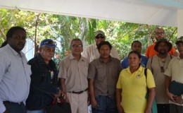 Permanent Secretary of the Department of Natural Resources and the Environment, Joslyn McKenzie (immediate left), Minister of Governance, Raphael Trotman (centre back row), Advisor to the Department, Clayton Hall (immediate right) and Commissioner of the Protected Areas Commission, Damian Fernandes (in orange) with the Representatives and Toshaos of Region 9’s KMRDG.