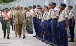 INSPECTION TIME: National Security Minister Carl Alfonso inspects the troops at the T&T Cadet Force’s annual camp at the Barataria North Secondary School yesterday. 