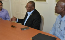 Alexei Ramotar (left) and Minister of State Joseph Harmon (centre) during their recent meeting.
