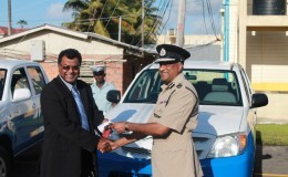 Minister of Public Security Khemraj Ramjattan (left) making the presentation to Commissioner   of Police Seelall Persaud.
