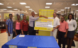 President of the AAG, Aubrey Hutson (fourth from left) is all smiles as he received the sponsorship cheque today from Courts (Unicomer Guyana Inc.) Managing Director, Clyde De Haas. 