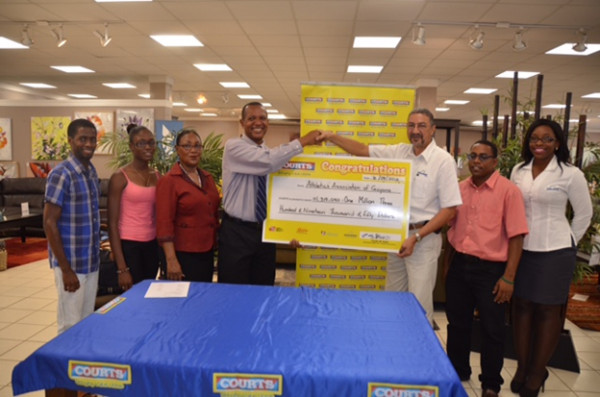 President of the AAG, Aubrey Hutson (fourth from left) is all smiles as he received the sponsorship cheque today from Courts (Unicomer Guyana Inc.) Managing Director, Clyde De Haas. 