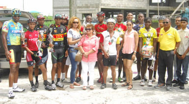 Winners and runners up of this year’s 11th annual Reagan Rodrigues road race pose with their winning spoils with Hassan Mohamed and members of the Rodrigues’ family. (Orlando Charles photo) 
