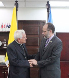 Secretary-General of the Caribbean Community Ambassador Irwin LaRocque (right) accepting the credentials of the first ever Ambassador of the Vatican to the Community, Archbishop Nicola Girasoli. (CARICOM photo) 