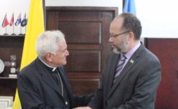 Secretary-General of the Caribbean Community Ambassador Irwin LaRocque (right) accepting the credentials of the first ever Ambassador of the Vatican to the Community, Archbishop Nicola Girasoli. (CARICOM photo)