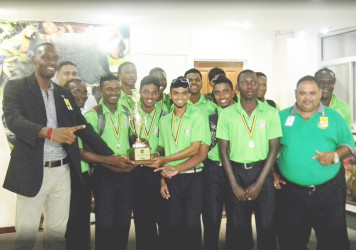 Director of Sport Chris Jones and GCB president Drubahadur with the victorious Guyana U19 team at the cheddi Jagan international airport on Monday night.