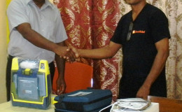 Sharir Chan (right) handing over the equipment to Dr. Mohamed Riyasat