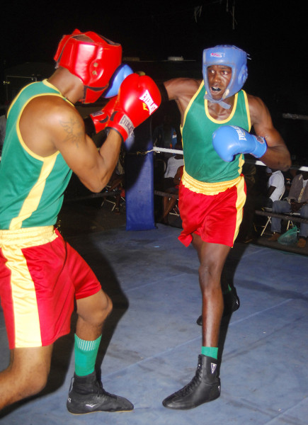 Punches throwing in the action packed bout involving Mickle Sancho (right) and Kevin DeFreitas on Sunday night at the East Ruimveldt Community Centre Ground. (Orlando Charles photo) 