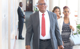 Finance Minister Winston Jordan on the way to deliver his budget yesterday
