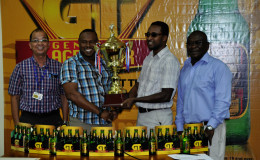 Tournament Coordinator Troy Mendonca (2nd left) collecting the championship trophy from Banks DIH Brand Manager Jeff Clement while Banks DIH Brand Manager of Beers Brian Cho-Hen (left) and Communications Director Troy Peters (right) look on following the launch of the inaugural GT Beer Futsal Tournament