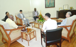 In this Ministry of the Presidency photo, Minister of State, Joseph Harmon is at left and Chinese Ambassador Zhang Limin is at right.