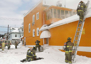 Schenectady firefighters battle the fire at the Bakery after flames  broke out. (Daily Gazette photo) 