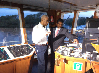 President David Granger being given a tour of the dredge by the Chief Executive Officer of  GAICO Construction & General Services Inc, Komal Singh. 