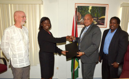 Minister of Governance Raphael Trotman (second from right) exchanging the MoU with Aiesha Williams, Head of Office, WWF Guianas. (Ministry of the Presidency photo)