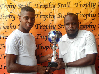 Tournament Coordinator Eson Pyle (right) collecting the championship trophy from a Trophy Stall Representative 