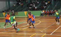 Sparta Boss’s Sheldon Shepherd (left), Travis Grant (centre) and Deon Alfred (2nd right) surrounding an Alexander Village player in their attempts to challenge for the ball during their team’s matchup on the opening night of the GT Beer Futsal Championship.