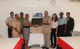 In photo,  Commissioner of Police Seelall Persaud, (fourth from right), is seen receiving the computer from Innovative Mining Company Official Mohini Heera. They are flanked by members of the Help Line’s Steering Committee.
 
