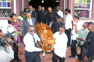 Pall bearers carrying the casket of Christobel Hughes out of St Andrew’s Kirk. (Photo by Keno George) 