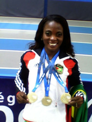 Alisha Fortune proudly smiling with the three World Masters Athletic Outdoor Championship gold medals she won in Lyon, France.   