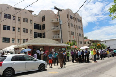 GRA employees outside the agency’s Camp Street headquarters after a tremor on July 16th. GRA Board Chairman Rawle Lucas confirmed to Stabroek News that cracks developed in the building after this event. (Stabroek News file photo)