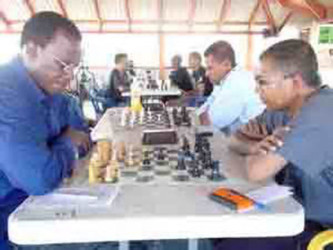 Loris Nathoo (r) opposes Frankie Farley in an earlier chess tournament. Both players are expected to participate in the Forbes Burnham Memorial Chess Tournament, and both are among the favourites to win.