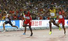 Usain Bolt of Jamaica (2nd R) crosses the finish line ahead of Justin Gatlin of the U.S. (3rd L) to win the men's 100 metres final during the 15th IAAF World Championships at the National Stadium in Beijing, China August 23, 2015. 