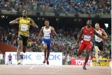 Sprint sweep for brilliant Bolt in Beijing: Usain Bolt of Jamaica (L) crosses the finish line ahead of Justin Gatlin (2nd R) from the U.S., Zharnel Hughes of Britain (2nd L) and Ramil Guliyev of Turkey in the men’s 200m final during the 15th IAAF World Championships at the National Stadium in Beijing, China yesterday. Reuters/Lucy Nicholson 